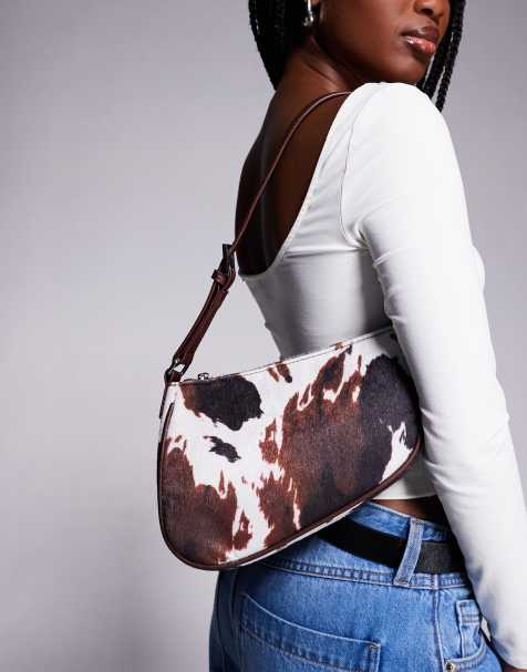 River Island cow print saddle shoulder bag in brown - view 1