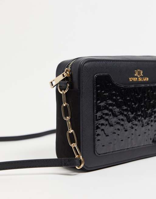 River Island embossed patent monogram boxy crossbody bag in black