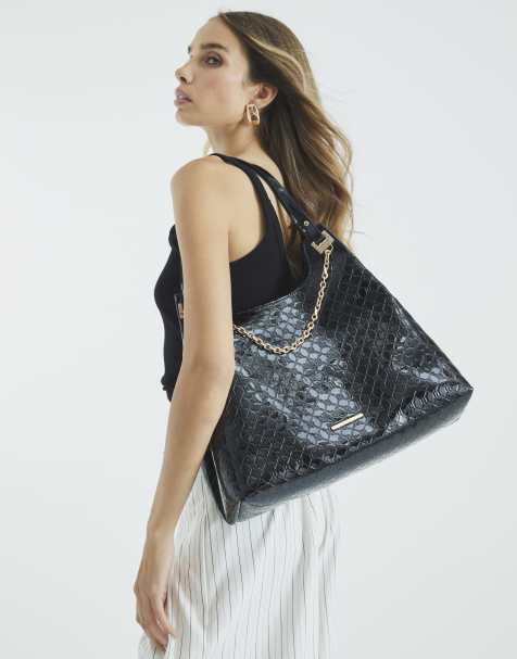 River Island Embossed ri monogram chain slouch bag in black - view 1