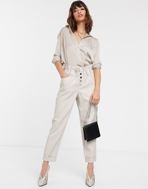 River Island faux leather peg trousers with gathered waist in off white