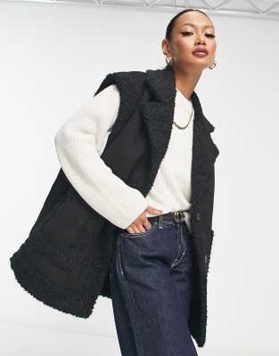 River Island faux shearling sleeveless jacket in black