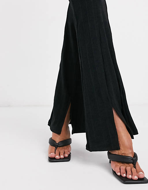  River Island frill waist ribbed flared trousers in black 