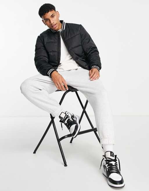 River Island – Gesteppte Bomberjacke in Schwarz im Collegejacken-Stil