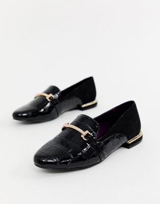 black flat shoes with gold buckle