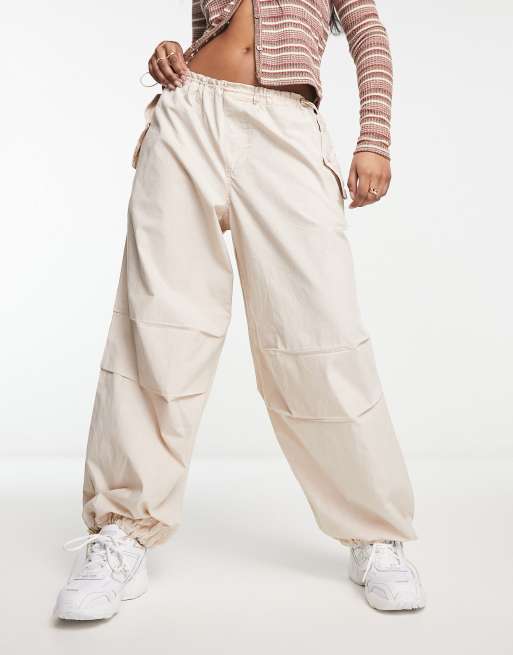 River Island low rise parachute cargo trouser in beige | ASOS