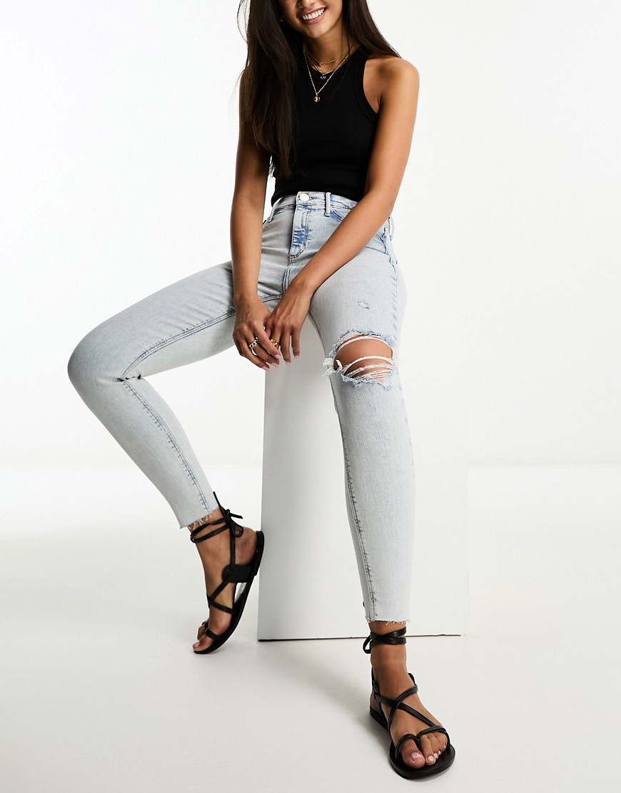 River Island Molly mid rise skinny jean with ripped knee in light blue wash