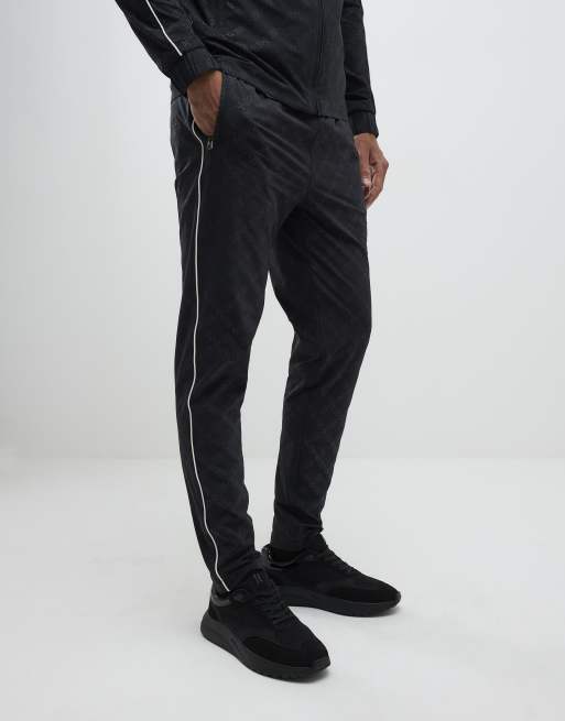River Island Monogram piped joggers in black