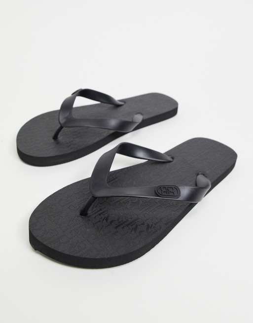 River Island monogrammed flip flops in grey | ASOS