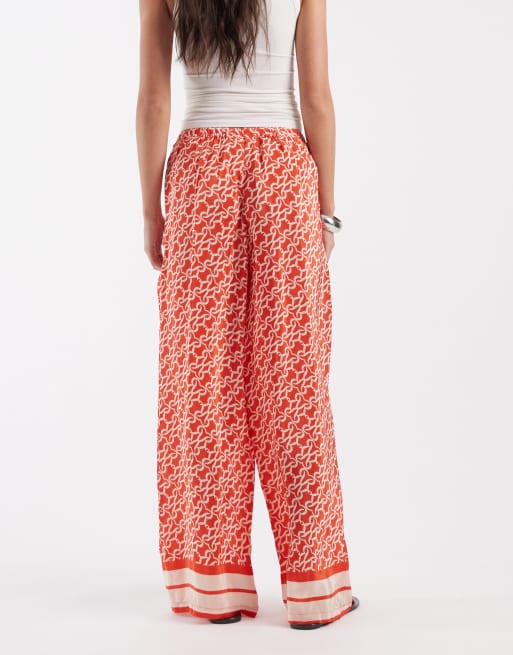 River Island monogrammed print pants in orange , 2 of 5
