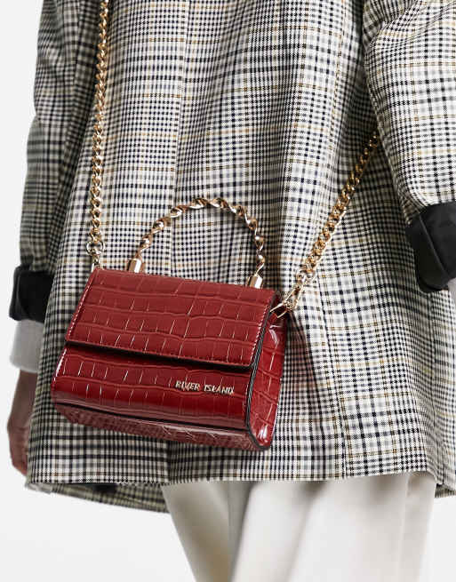 River Island – Mörkröd miniväska med snurrat handtag