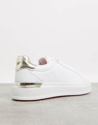 white sneakers with gold trim