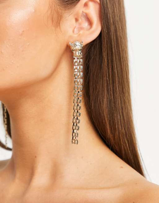 River Island - Orecchini pendenti a catenina a forma di testa di leone color oro