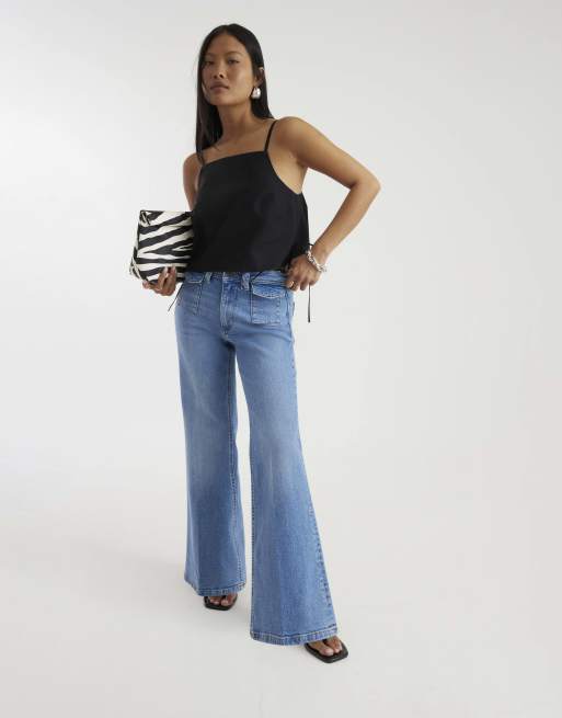 River Island Petite Petite denim high waisted relaxed flare jeans in denim - light