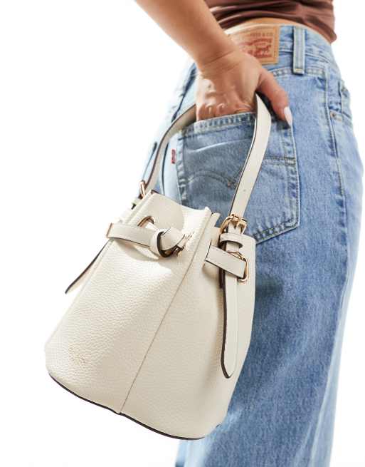 River Island pinched edge bucket bag in cream | ASOS