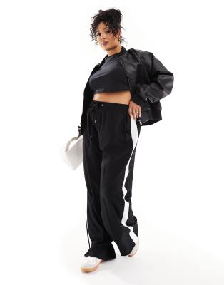 River Island Plus trackies with side stripe in black