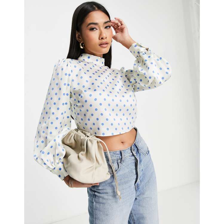 River Island polka dot tie back high neck blouse is blue ASOS