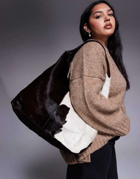 River Island pony hair cow print leather slouch bag in dark brown - view 1