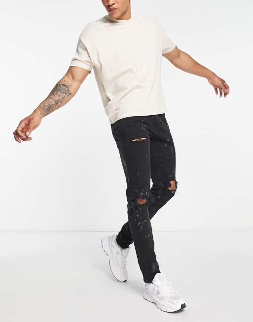 Black ripped skinny jeans best sale river island