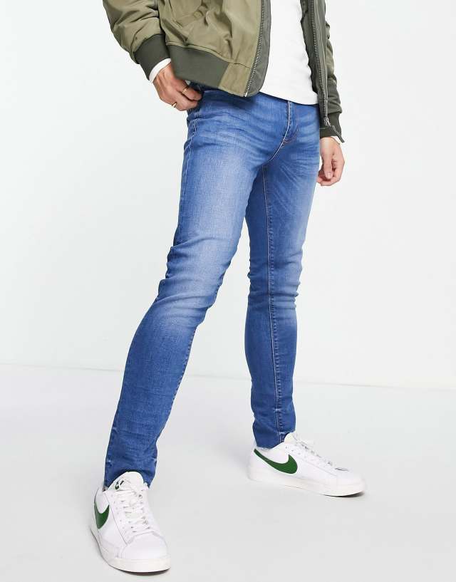 River Island skinny jeans with raw hem in blue