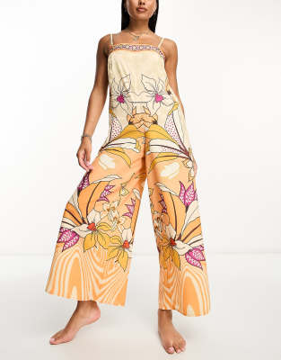 River Island - Strand-Jumpsuit mit tropischem Print in Orange und weitem Bein