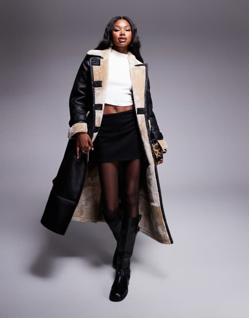 River Island - Trench in pelle sintetica nero con cintura e dettagli in montone