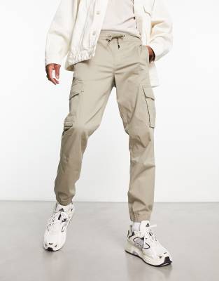 River Island washed look cargos in beige | ASOS