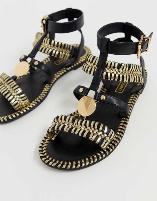 Black and gold online gladiator sandals