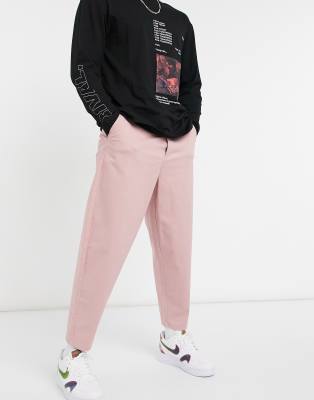 Брюки и чиносы Розовые суженные книзу чиносы в стиле oversized ASOS DESIGN-Розовый цвет