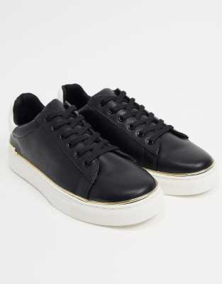 black trainers with gold trim