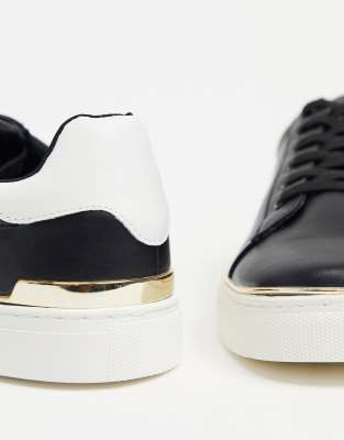 black trainers with gold trim