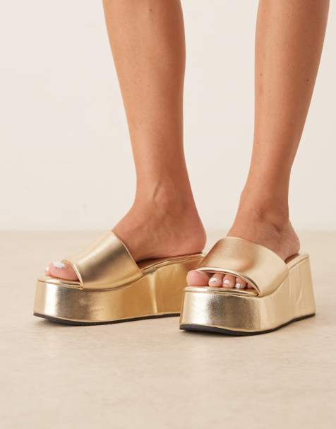 Sandalias doradas estilo mules con plataforma plana Tornado de ASOS DESIGN - view 1