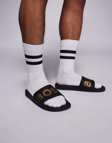 Sandalias negras y doradas con logo en contraste Aryeh de BOSS - view 1