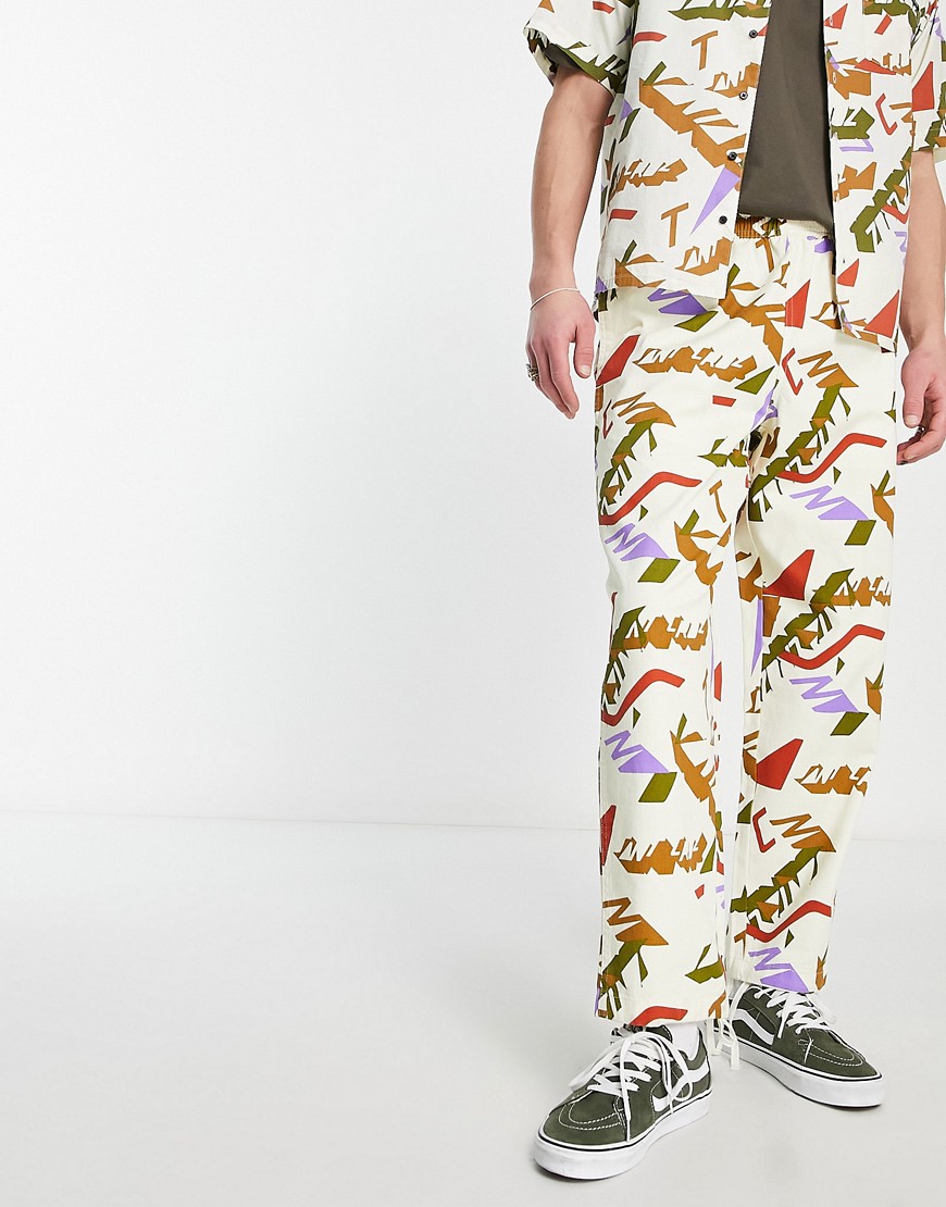 Santa Cruz classic label unisex co-ord trousers in white with all over logo print