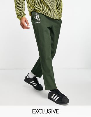 Santa Cruz Santa Cruz co-ord trousers in dark green with multiple placement prints exclusive to ASOS