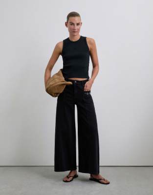 Scalpers - Jeans in Schwarz mit Hosenrock-Schnitt und Nietendetails