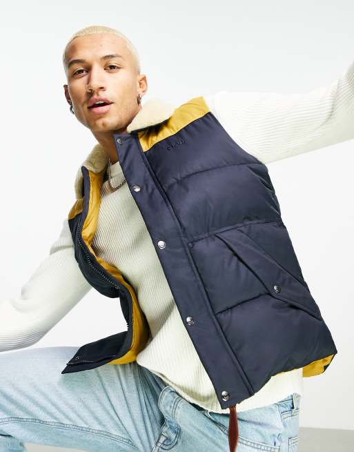 Schott Hills V faux fur collar contrast yoke puffer gilet in navy ASOS