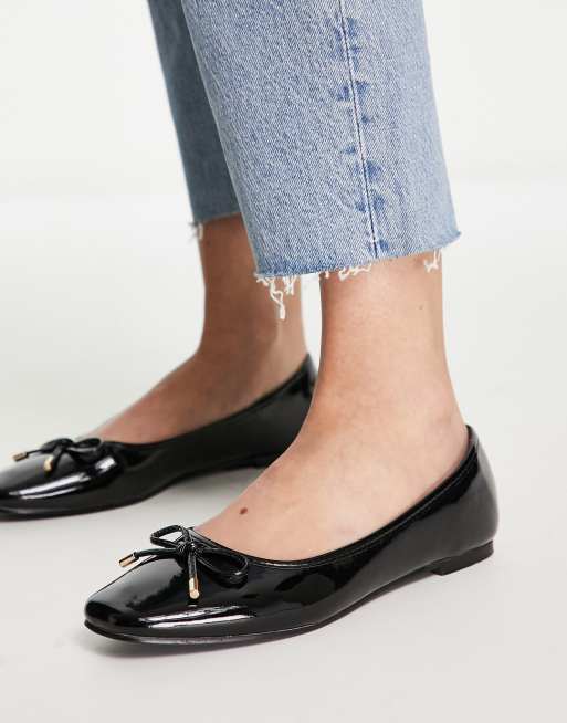 Black patent leather store flats with bow