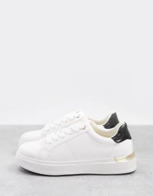 white sneakers with gold trim