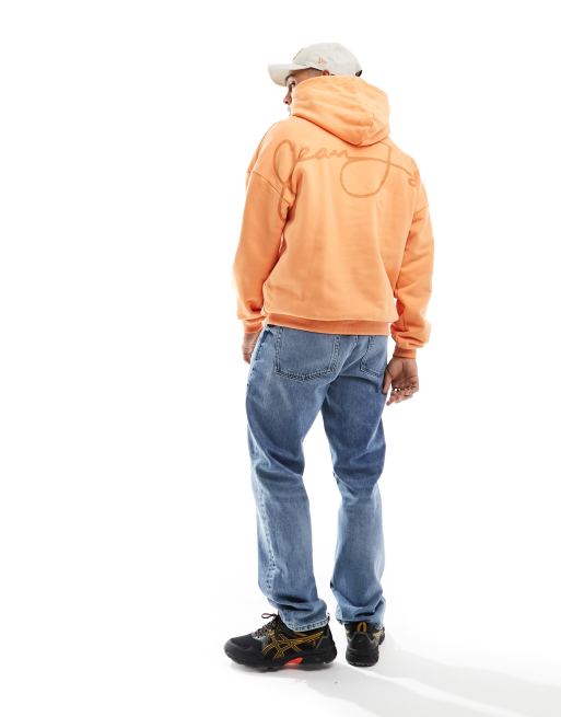 Sean John script pullover hoodie in orange with chest print