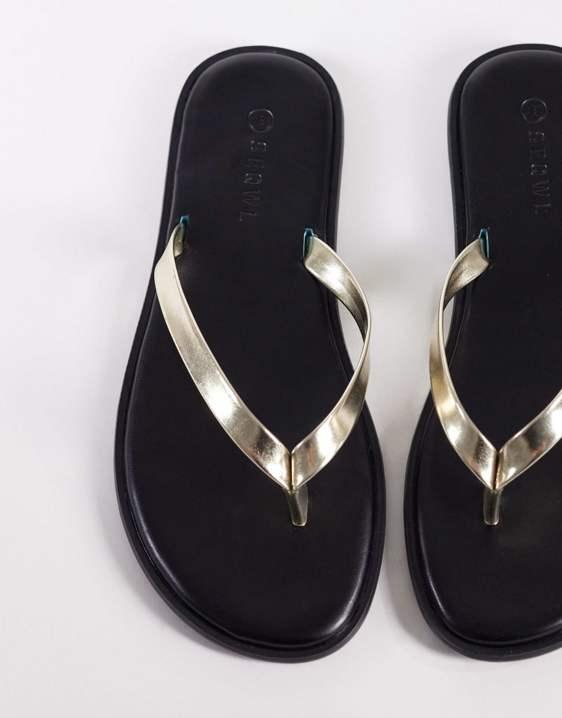 seqwl jelly flip flops in black with gold strap