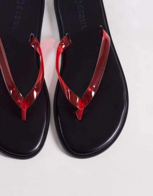 SEQWL jelly flip flops in black with red straps