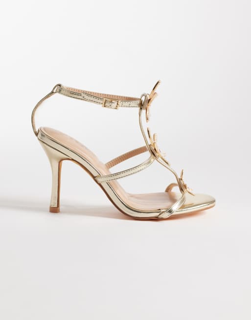 SEQWL - Lolly - Sandali con tacco color oro decorati con stelle marine