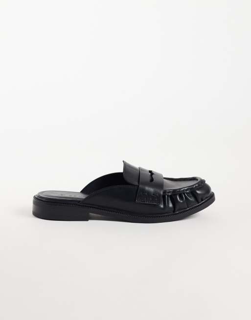 SEQWL - Mules tipo penny loafer en negro de piel sintética, 1 de 4