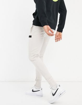 фото Серые узкие джоггеры с логотипом из флока the couture club-серый