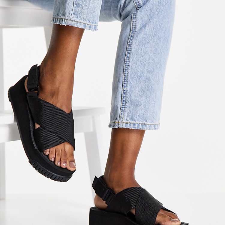 Shaka Fiesta platform sandals with crossover strap in black Shaka Fiesta platform sandals with crossover strap in black