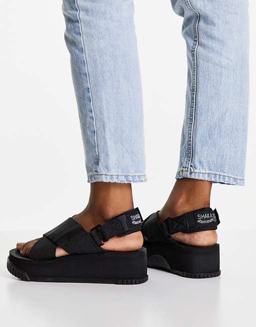 Shaka Fiesta platform sandals with crossover strap in black Shaka Fiesta platform sandals with crossover strap in black