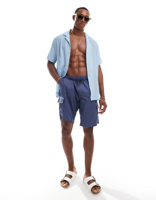 Shorts de baño azul marino de corte alargado con bolsillos cargo de ASOS DESIGN 