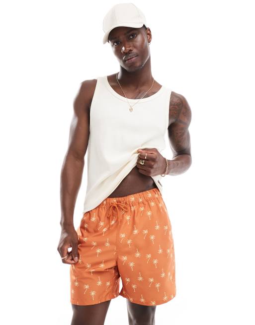 Shorts de baño naranjas de largo medio con estampado de palmeras de ASOS DESIGN 