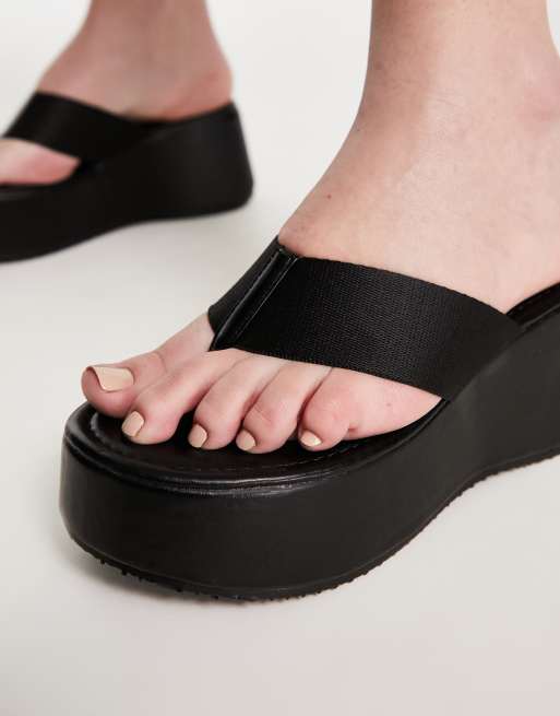 Truffle Collection Wide Fit flatform toe thong sandals in black, ASOS