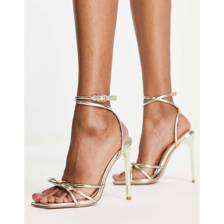 ASOS Design Hitched Bow Detail Mid Heeled Sandals in Gold